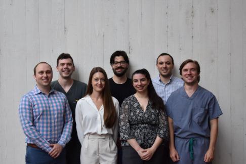 seven radiology residents smiling and standing side by side