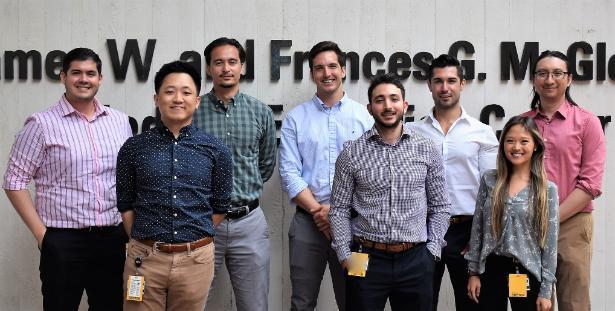 eight radiology residents standing side by side