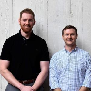 Andrew Pritchard standing next to Kendal Angell wearing casual attire